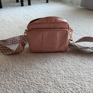 Elegant Pink Crossbody Bag with Patterned Strap. Purchased in 2024.